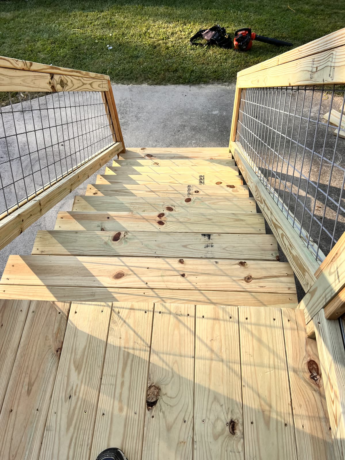 Wooden deck staircase with metal railings