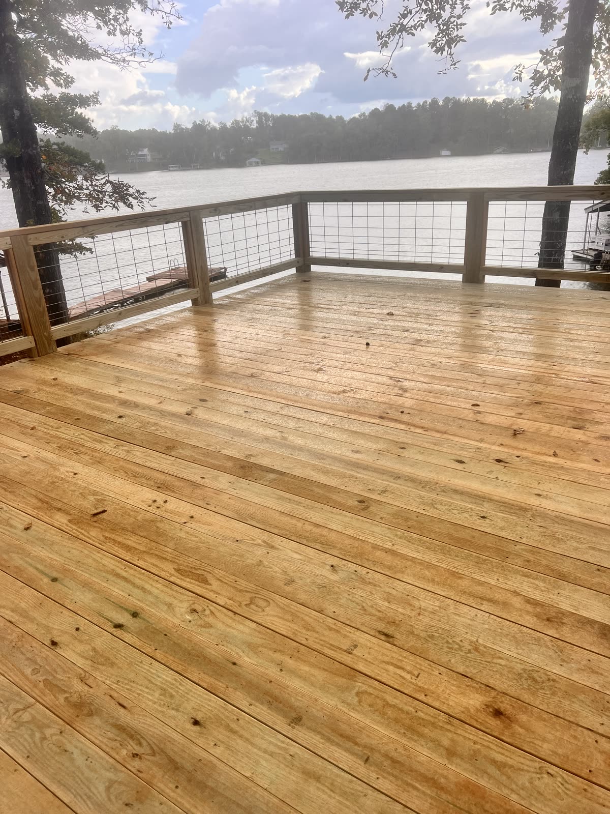 Custom wooden deck with lake view by Caballero C&L Remodeling