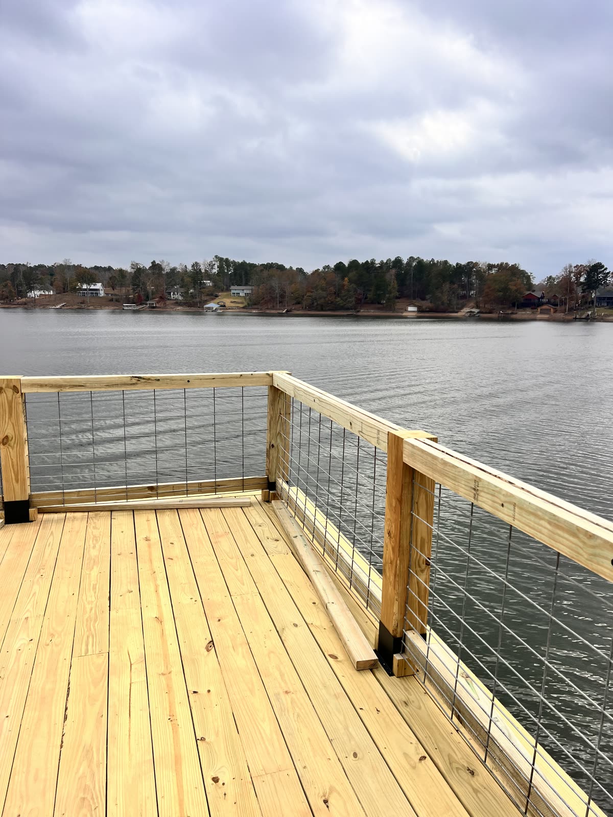 Beautiful wooden deck overlooking a lake by Caballero C&L Remodeling