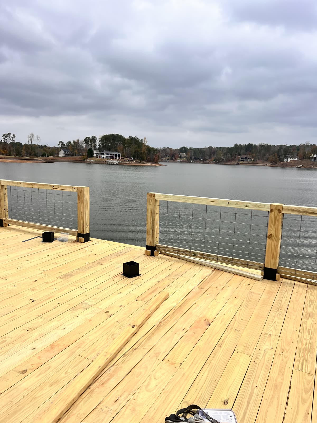 Completed deck with railings by Caballero C&L Remodeling