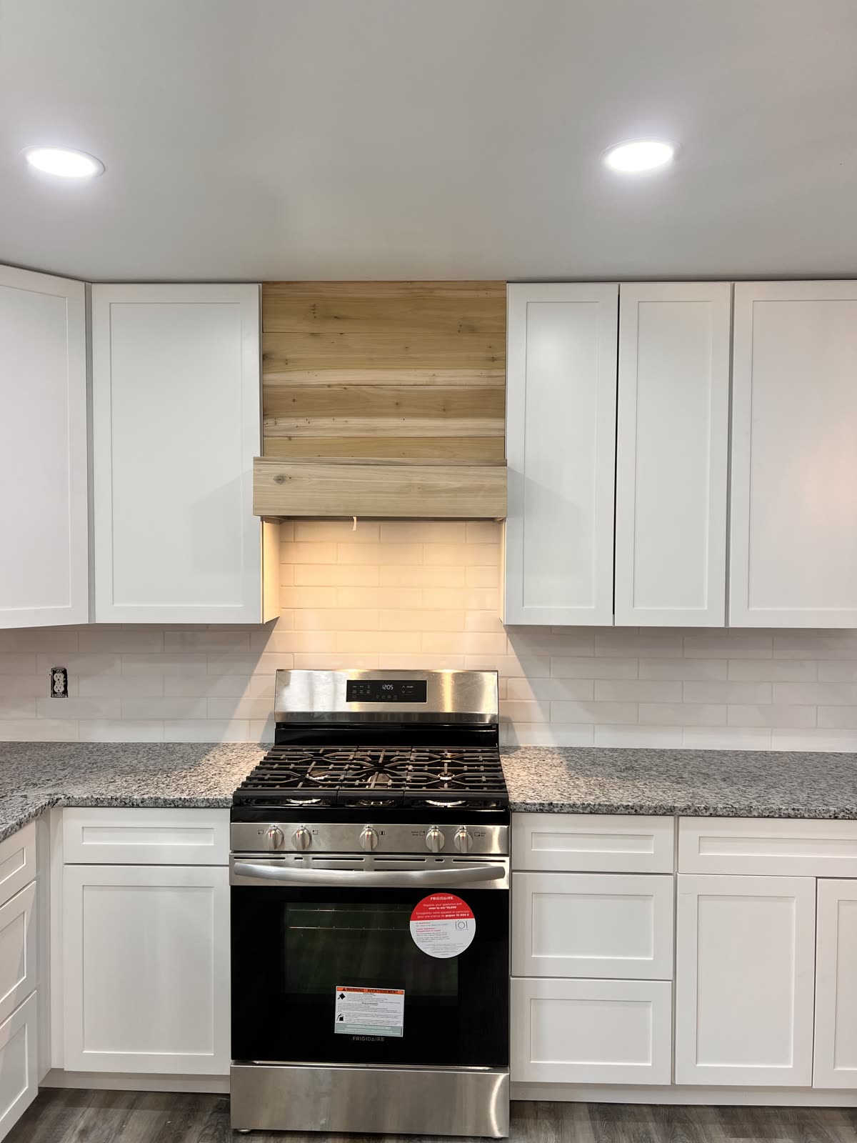 Modern kitchen remodel with white cabinets and stainless steel appliances by Caballero C&L Remodeling