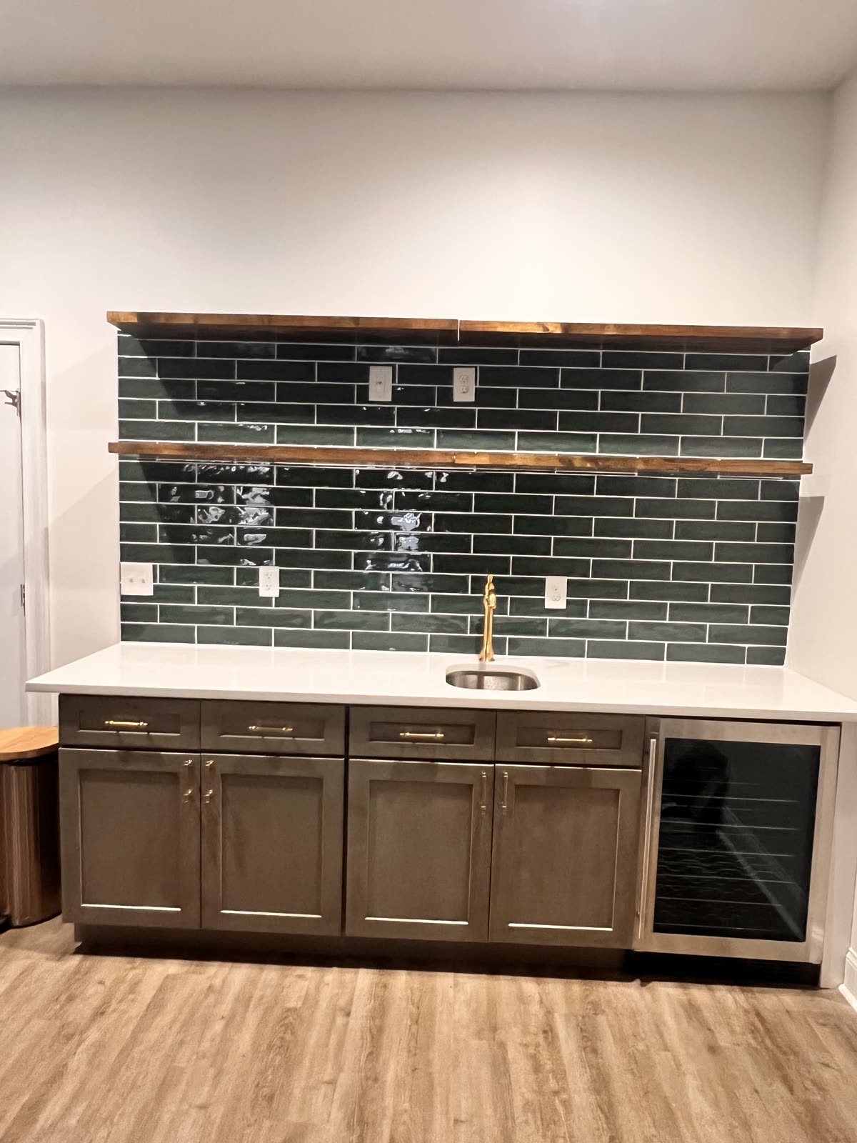 Kitchen remodel with dark subway tile backsplash by Caballero C&L Remodeling
