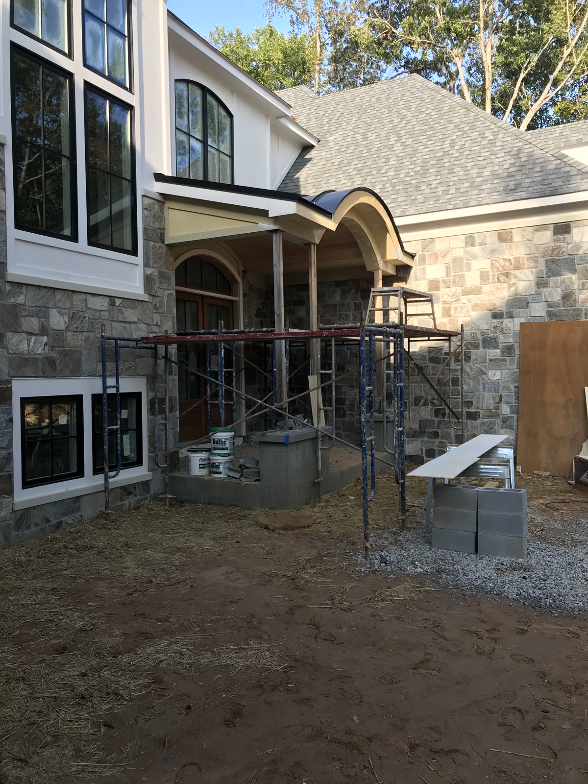 Porch construction with stonework by Caballero C&L Remodeling