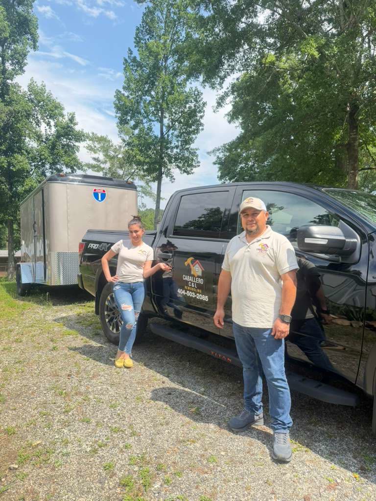 Team members beside Caballero branded truck